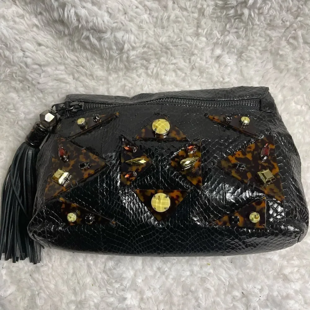 Rafe Black patent snake skin print clutch embellished with jewels and tassel .